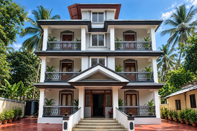 The Misquita Comforts guest house in Benaulim, a three-storey Goan building of studio apartments, set in a garden.