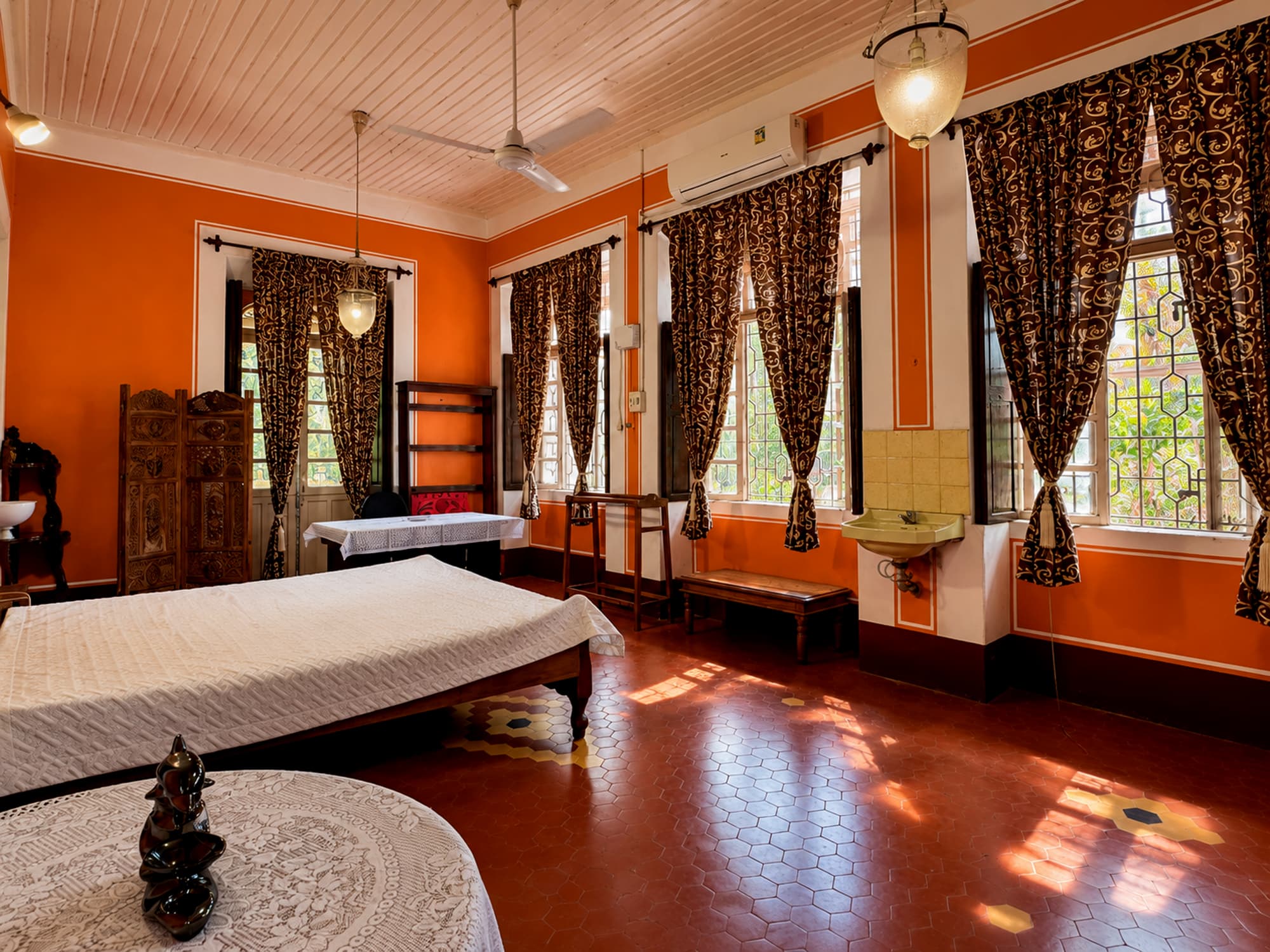 A bedroom at Misquita Heritage with period furniture and wooden cupboards.